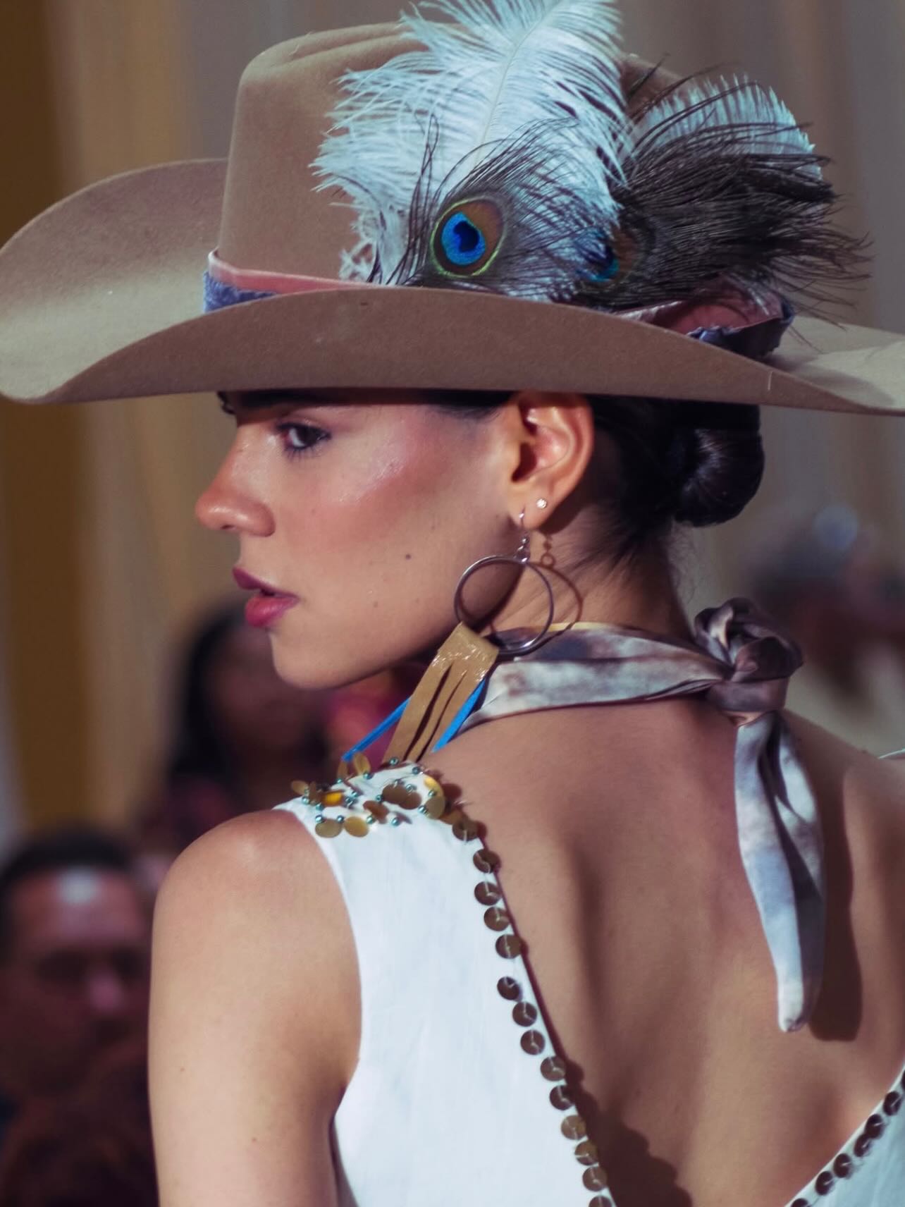 Editorial profile — peacock-feather hat, sculpted light