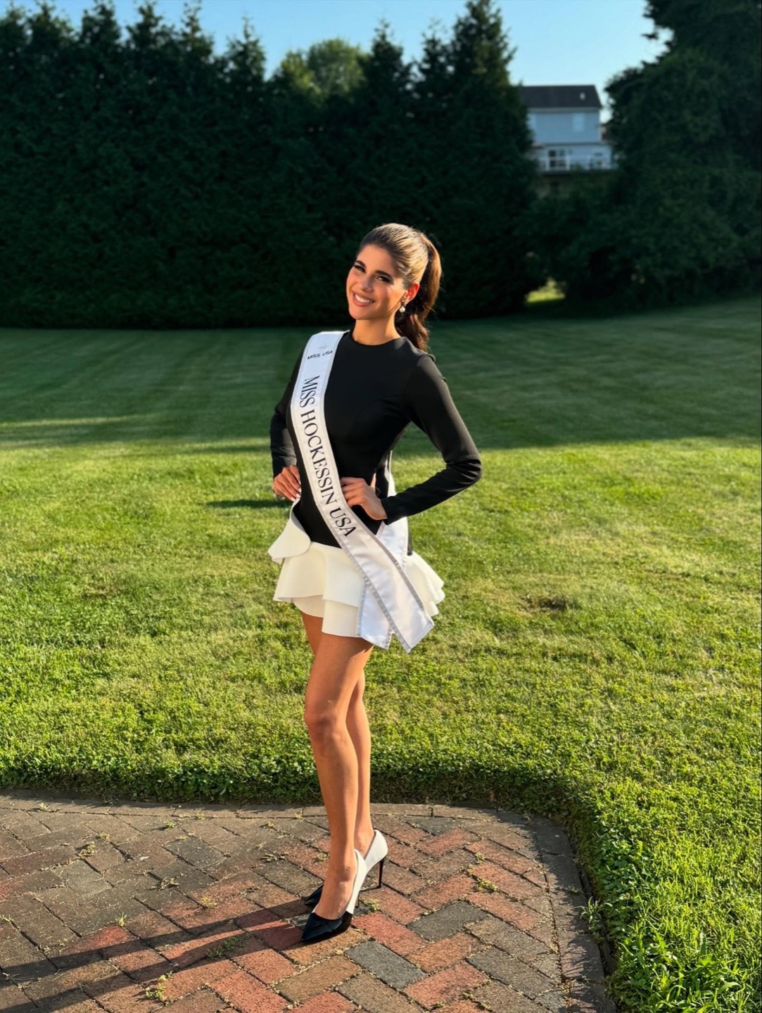 Pageant portrait — titleholder sash, golden-hour lawn